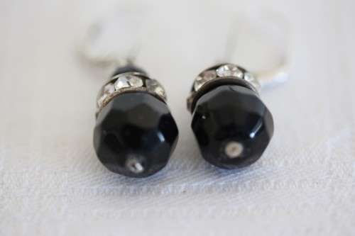 A gorgeous matching black stone and silver metal pendant and earring set with diamante
