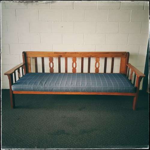 A very charming 3-seater solid Oregon daybed with an upholstered cushion - perfect for sun room!