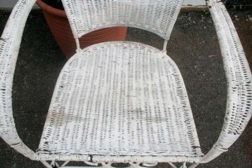 A gorgeous white painted wicker "all weather" outdoor/ patio table with a glass top and a chair