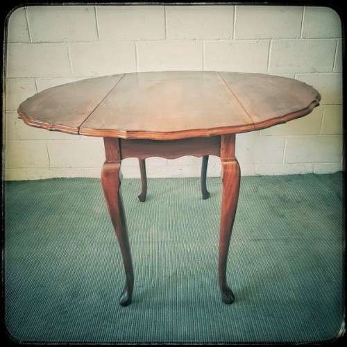 A stunning vintage solid imbuia drop-leaf dining table with beautiful slender Queen Anne legs