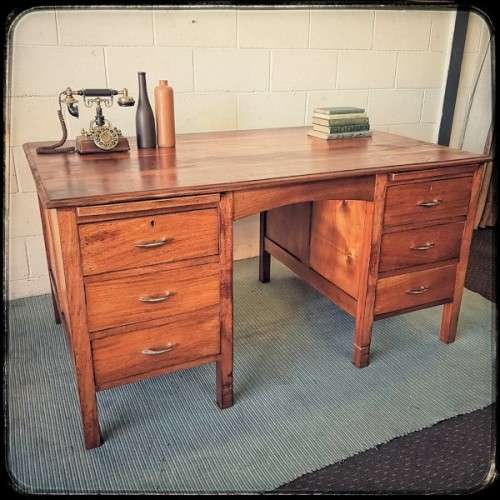 A beautiful vintage 6-drawer solid teak knee-hole partners desk with pull-out writing tops