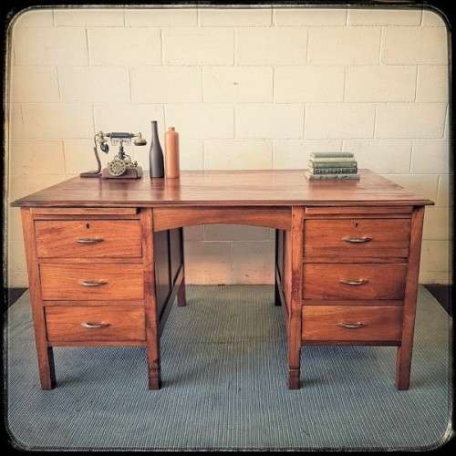 A beautiful vintage 6-drawer solid teak knee-hole partners desk with pull-out writing tops