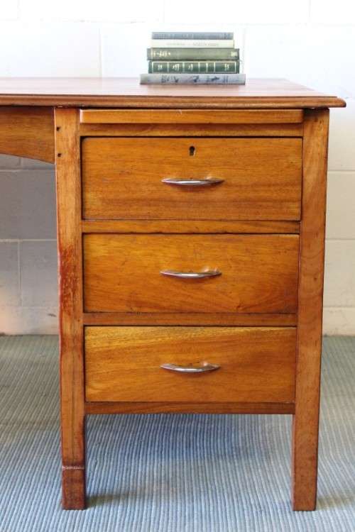 A beautiful vintage 6-drawer solid teak knee-hole partners desk with pull-out writing tops