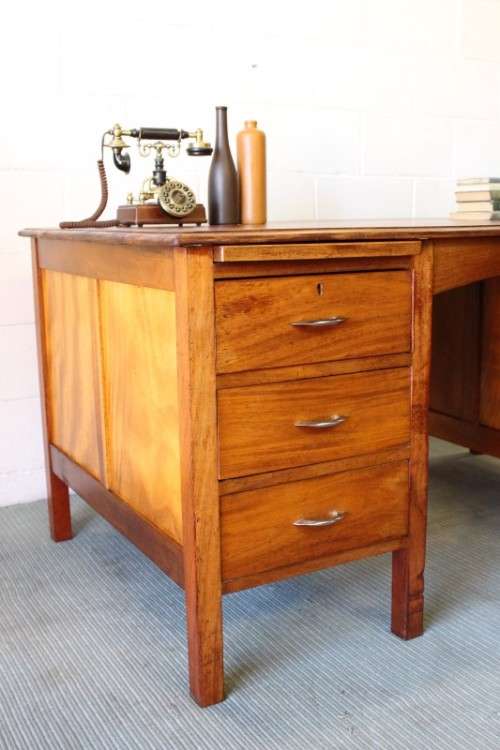 A beautiful vintage 6-drawer solid teak knee-hole partners desk with pull-out writing tops