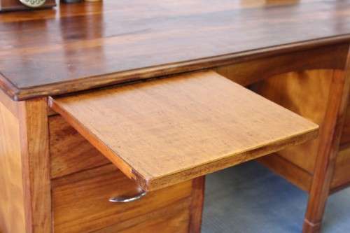 A beautiful vintage 6-drawer solid teak knee-hole partners desk with pull-out writing tops