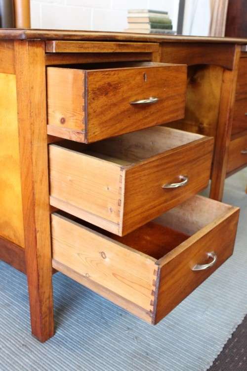A beautiful vintage 6-drawer solid teak knee-hole partners desk with pull-out writing tops