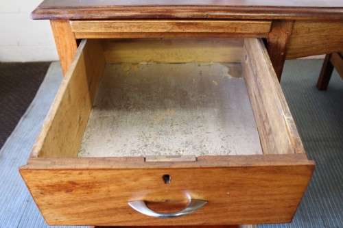 A beautiful vintage 6-drawer solid teak knee-hole partners desk with pull-out writing tops