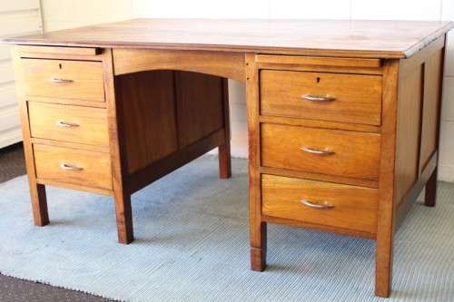 A beautiful vintage 6-drawer solid teak knee-hole partners desk with pull-out writing tops