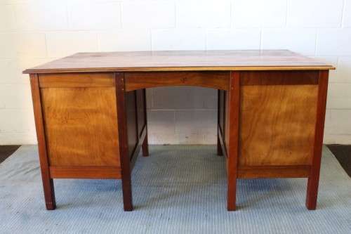 A beautiful vintage 6-drawer solid teak knee-hole partners desk with pull-out writing tops