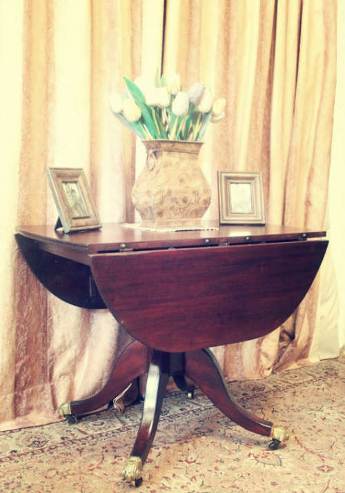 A fabulous stylish vintage drop leaf occasional table with ornate brass capped feet on castors
