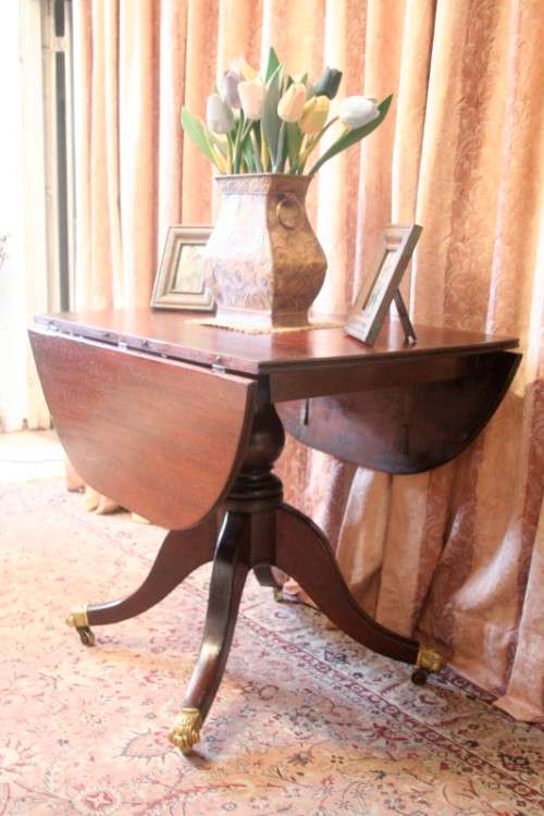 A fabulous stylish vintage drop leaf occasional table with ornate brass capped feet on castors