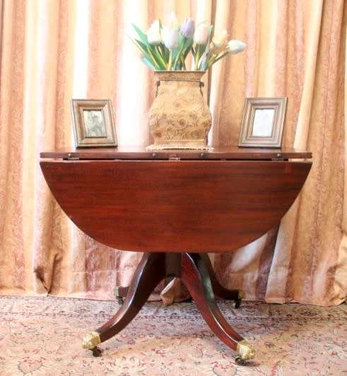 A fabulous stylish vintage drop leaf occasional table with ornate brass capped feet on castors