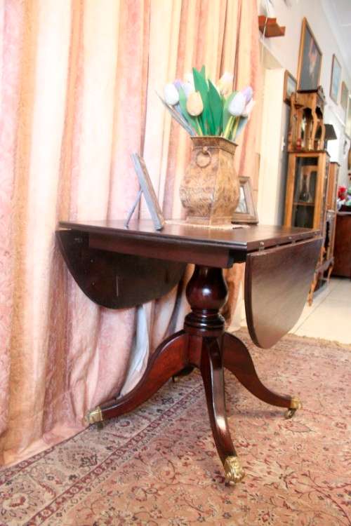 A fabulous stylish vintage drop leaf occasional table with ornate brass capped feet on castors