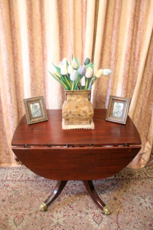 A fabulous stylish vintage drop leaf occasional table with ornate brass capped feet on castors