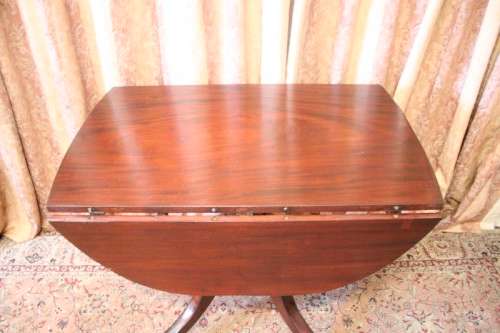 A fabulous stylish vintage drop leaf occasional table with ornate brass capped feet on castors