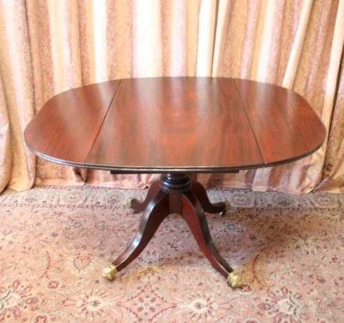 A fabulous stylish vintage drop leaf occasional table with ornate brass capped feet on castors