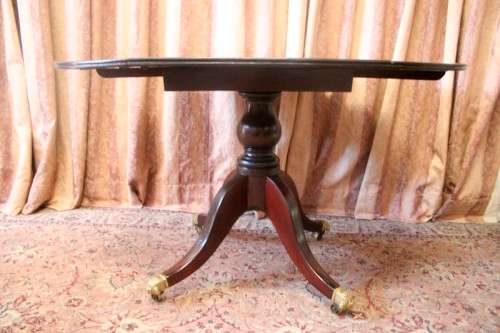 A fabulous stylish vintage drop leaf occasional table with ornate brass capped feet on castors