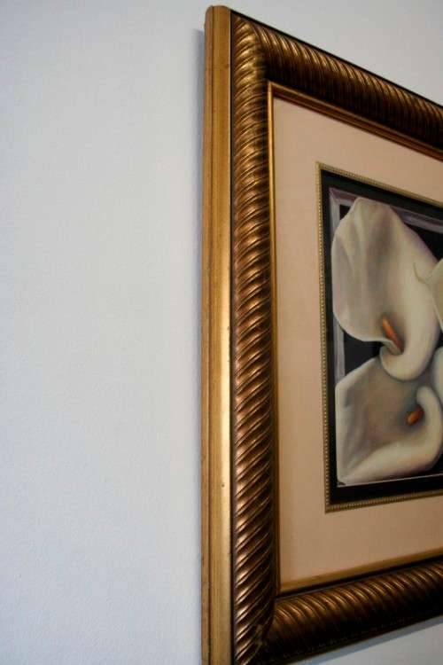 An exquisite signed "JM" print framed behind glass of four Arum Lilies. Stunning in all areas.