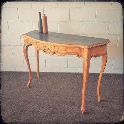A beautiful ornately carved Yew wood console/ hall table with an ebony stained top on cabriole legs