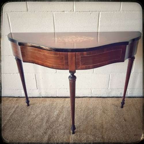 A stunning Italian "half-moon" console table with incredible marquetry and rail inlay detailing