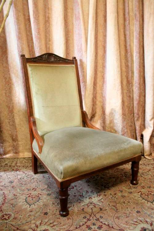 **RS17**  A hand-carved antique Victorian slipper/ nursing chair upholstered in a soft green fabric