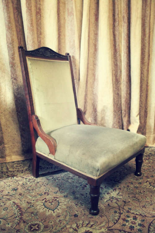 **RS17**  A hand-carved antique Victorian slipper/ nursing chair upholstered in a soft green fabric