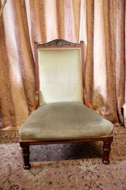 **RS17**  A hand-carved antique Victorian slipper/ nursing chair upholstered in a soft green fabric