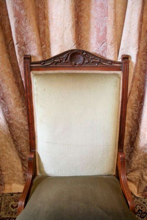 **RS17**  A hand-carved antique Victorian slipper/ nursing chair upholstered in a soft green fabric