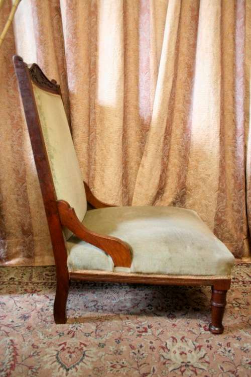 **RS17**  A hand-carved antique Victorian slipper/ nursing chair upholstered in a soft green fabric