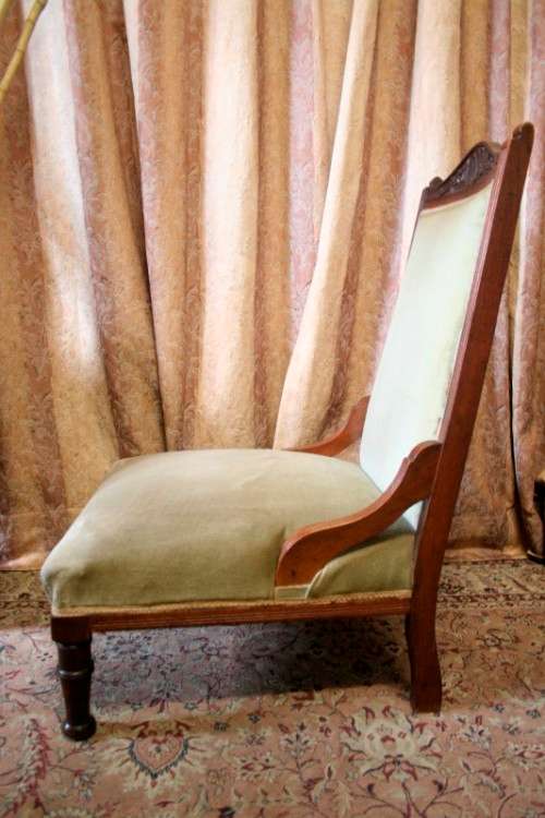 **RS17**  A hand-carved antique Victorian slipper/ nursing chair upholstered in a soft green fabric
