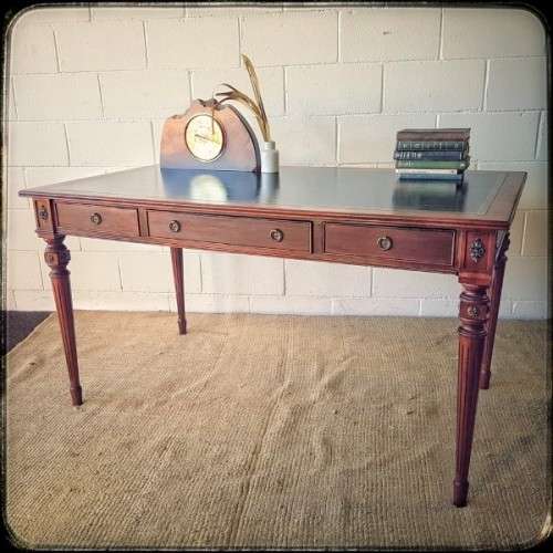 A beautifully detailed vintage Mahogany Regency leather-top library desk with drawers & fluted legs