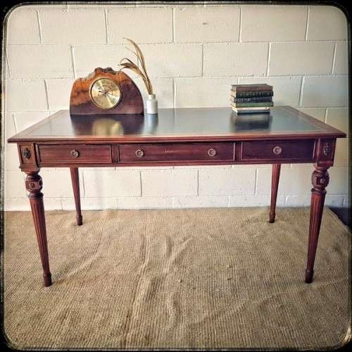 A beautifully detailed vintage Mahogany Regency leather-top library desk with drawers & fluted legs