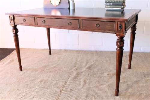 A beautifully detailed vintage Mahogany Regency leather-top library desk with drawers & fluted legs