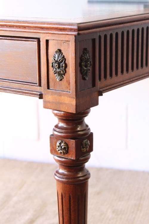 A beautifully detailed vintage Mahogany Regency leather-top library desk with drawers & fluted legs