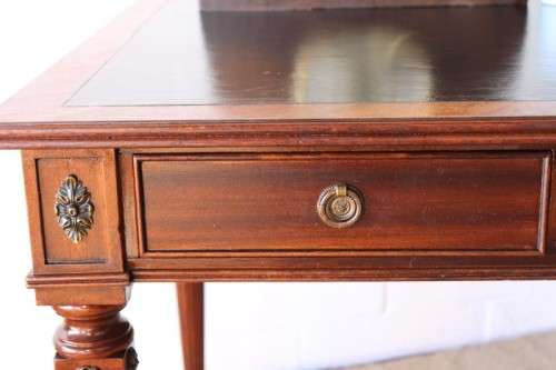 A beautifully detailed vintage Mahogany Regency leather-top library desk with drawers & fluted legs