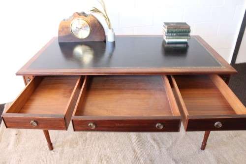 A beautifully detailed vintage Mahogany Regency leather-top library desk with drawers & fluted legs