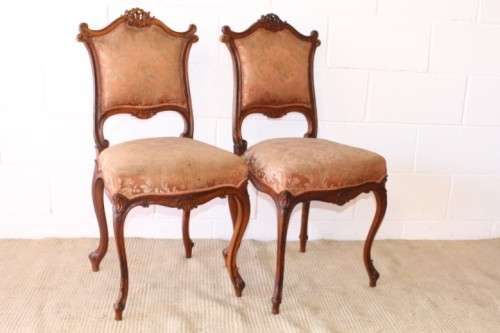 A stunning pair of hand carved ladies parlour chairs with a beautiful pink & cream brocade fabric