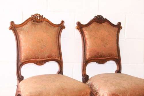 A stunning pair of hand carved ladies parlour chairs with a beautiful pink & cream brocade fabric