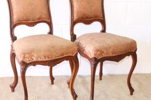 A stunning pair of hand carved ladies parlour chairs with a beautiful pink & cream brocade fabric