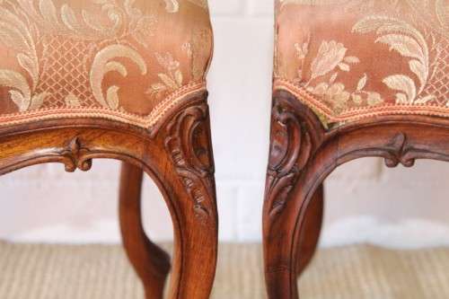 A stunning pair of hand carved ladies parlour chairs with a beautiful pink & cream brocade fabric