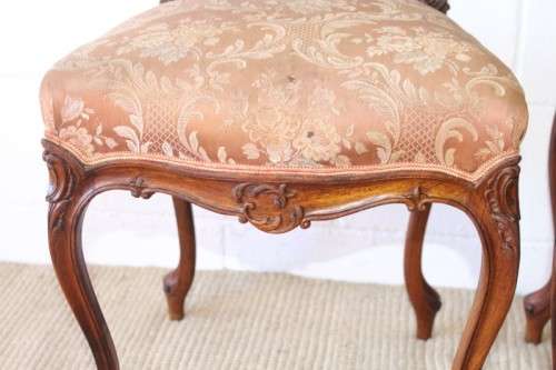 A stunning pair of hand carved ladies parlour chairs with a beautiful pink & cream brocade fabric