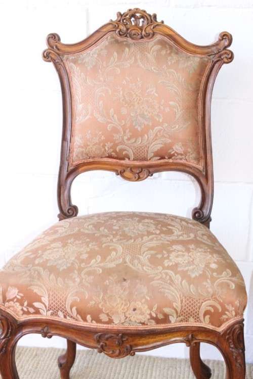 A stunning pair of hand carved ladies parlour chairs with a beautiful pink & cream brocade fabric