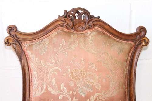 A stunning pair of hand carved ladies parlour chairs with a beautiful pink & cream brocade fabric