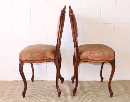 A stunning pair of hand carved ladies parlour chairs with a beautiful pink & cream brocade fabric