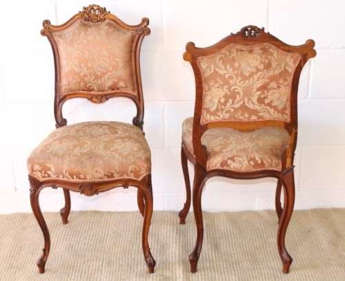 A stunning pair of hand carved ladies parlour chairs with a beautiful pink & cream brocade fabric