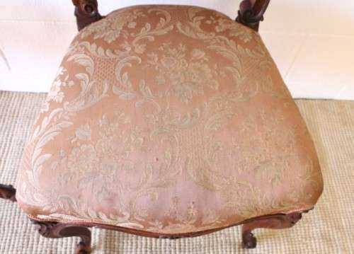 A stunning pair of hand carved ladies parlour chairs with a beautiful pink & cream brocade fabric