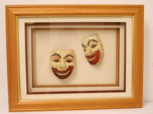 Two stunning mini ceramic masks in a lovely wooden boxed frame.