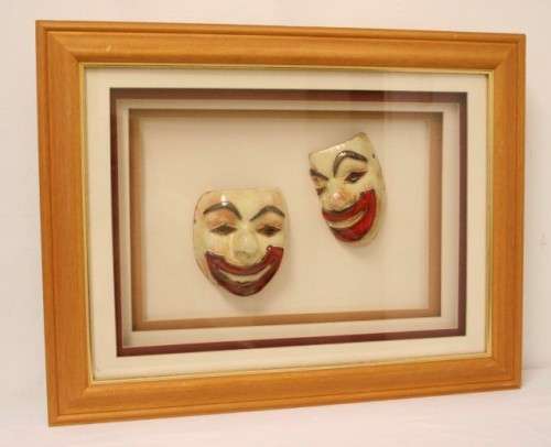 Two stunning mini ceramic masks in a lovely wooden boxed frame.