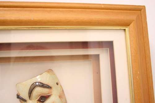 Two stunning mini ceramic masks in a lovely wooden boxed frame.