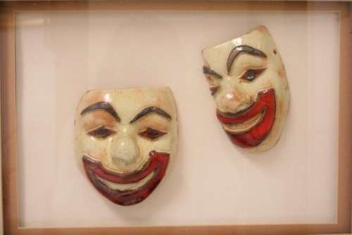 Two stunning mini ceramic masks in a lovely wooden boxed frame.
